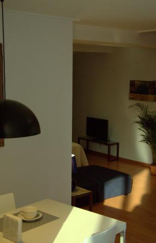 a living room with a bed and a table at Las Coles Apartasuites in Xàtiva