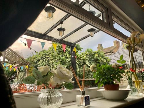 a window with flowers in a vase on a table at The Bay Horse, Masham in Masham