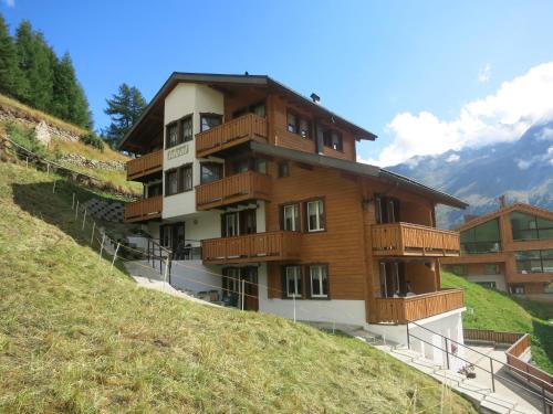 a building on the side of a hill at Chalet Ideal Saas-Fee in Saas-Fee