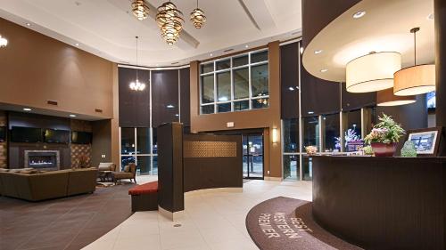 a lobby of a hotel with a waiting area and a lobby at Best Western Premier Freeport Inn Calgary Airport in Calgary
