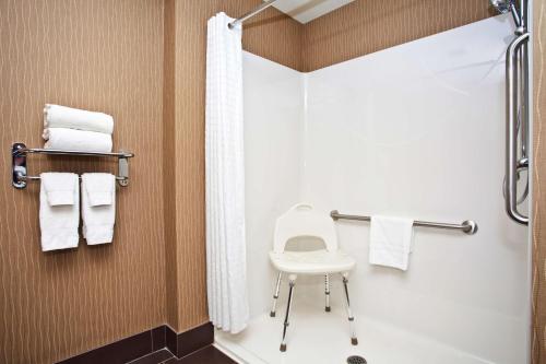 a bathroom with a toilet and a shower at Best Western Premier Freeport Inn Calgary Airport in Calgary