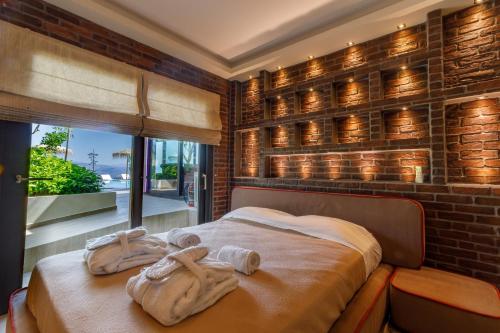 a bedroom with a bed with towels on it at KingsResidenceVilla in Nafplio