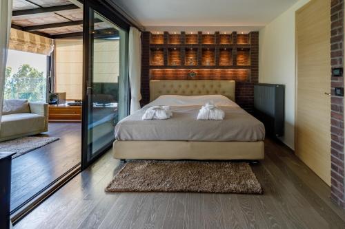 a bedroom with a bed with two towels on it at KingsResidenceVilla in Nafplio