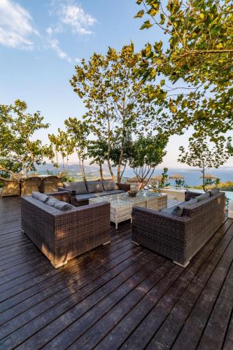 a wooden deck with two couches on top of it at KingsResidenceVilla in Nafplio