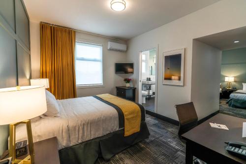 a hotel room with a bed and a desk at The Steveston Cafe & Hotel in Richmond