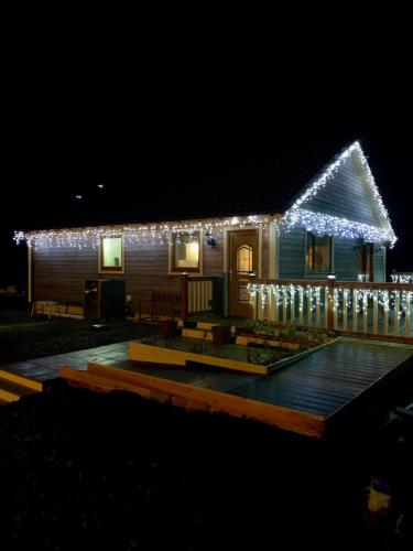 a house with christmas lights on it at night at Riverside Chalet Borve Isle of Lewis in Borve