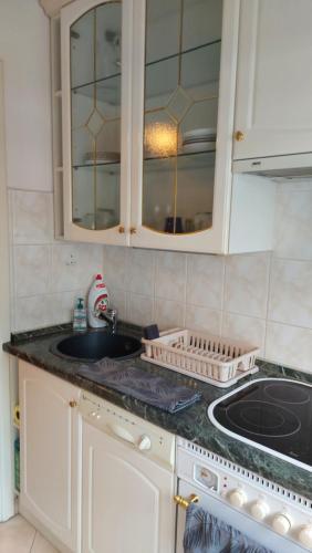 a kitchen with a sink and a counter top at Peró Apartman in Debrecen