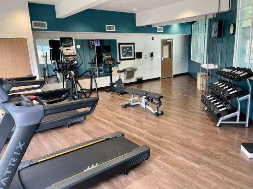 a gym with treadmills and machines in a room at Holiday Inn Express Hotel & Suites North Sequim by IHG in Sequim