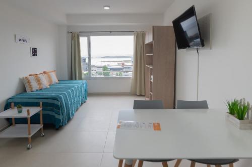 a living room with a bed and a tv in it at Happy Guest Apart 56 in Ushuaia