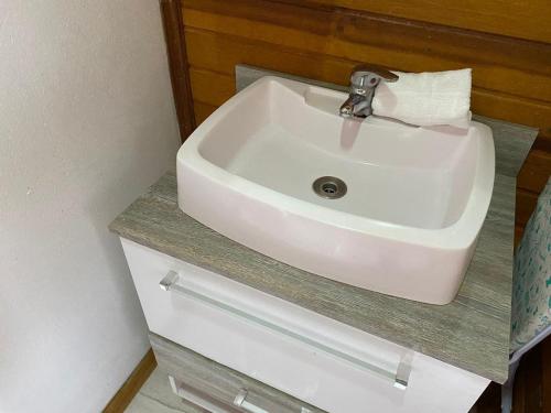 a white sink sitting on a counter in a bathroom at Chale Morada da Serra in Canela