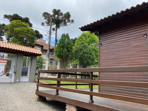 a wooden bench sitting in front of a building at Chale Morada da Serra in Canela