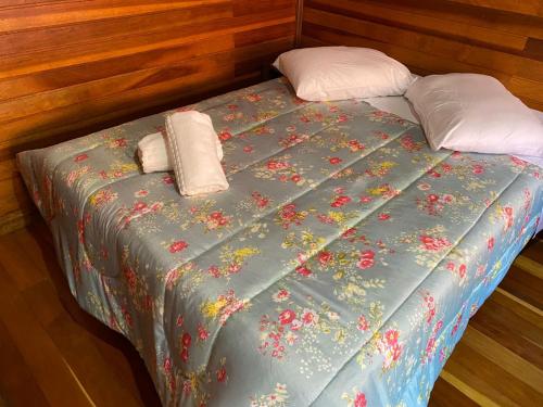 a bed with two pillows on top of it at Chale Morada da Serra in Canela