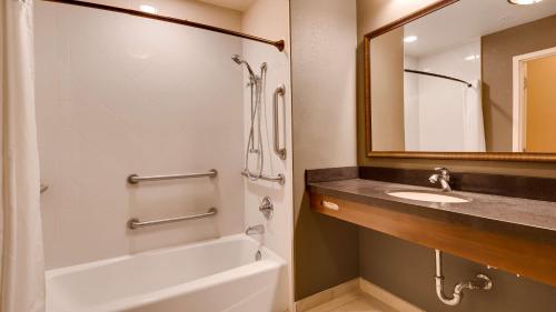a bathroom with a tub and a sink and a mirror at Best Western Plus Chandler Hotel & Suites in Chandler