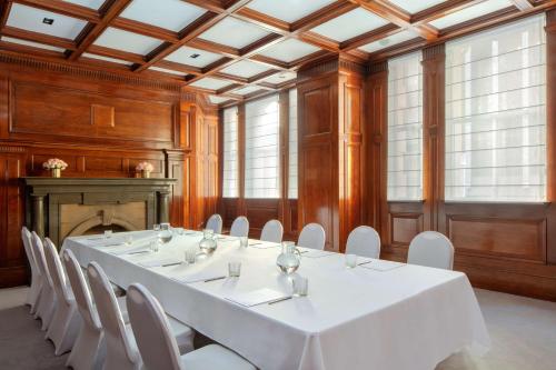 a large room with a white table and white chairs at Paradox Sydney in Sydney
