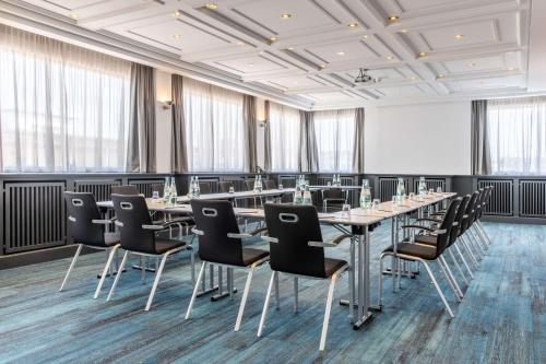a conference room with a long table and chairs at Radisson Blu Hotel Schwarzer Bock Wiesbaden in Wiesbaden