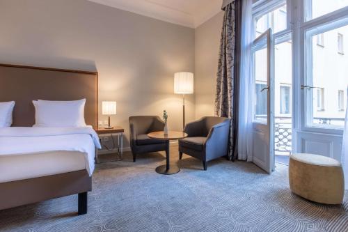 a hotel room with a bed and a window at Radisson Blu Hotel Schwarzer Bock Wiesbaden in Wiesbaden