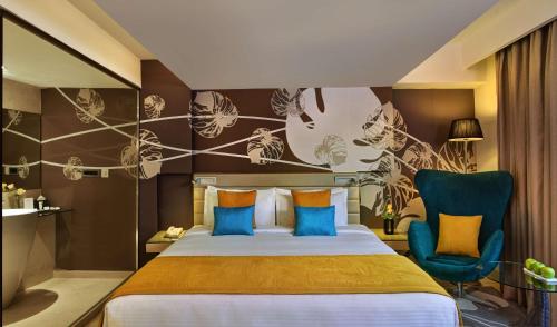 a hotel room with a bed and a chair at Country Inn & Suites By Radisson, Bengaluru Hebbal Road in Bangalore