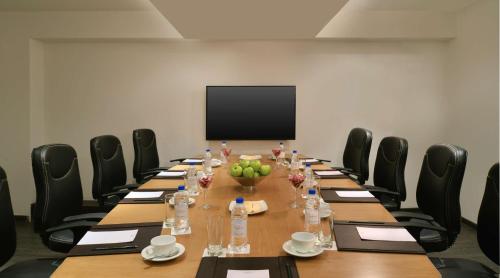 a conference room with a long table and chairs at Country Inn & Suites By Radisson, Bengaluru Hebbal Road in Bengaluru