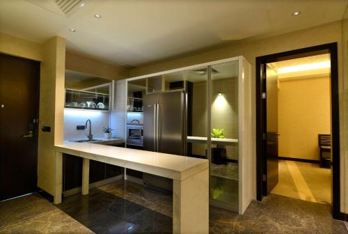 a kitchen with a counter and a refrigerator at Radisson Blu Chattogram Bay View in Chittagong