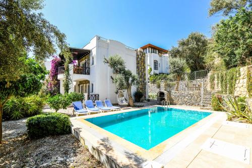 a swimming pool in the backyard of a house at Villa Leo Bodrum in Yalıkavak