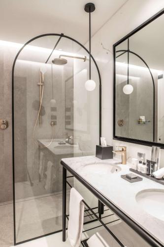 a bathroom with a shower and a sink and a mirror at Radisson Collection Hotel, Palazzo Nani Venice in Venice