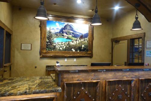 a bathroom with a large painting on the wall at Glacier International Lodge in Kalispell