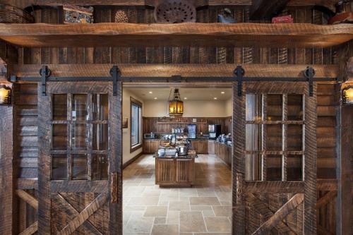 a large room with wooden doors and a kitchen at Glacier International Lodge in Kalispell