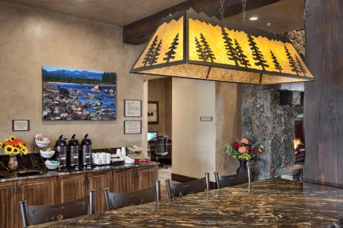 a large chandelier hanging over a table in a restaurant at Glacier International Lodge in Kalispell