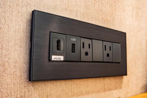 a black light switch on a wall at Mega Hotel in Chiayi City