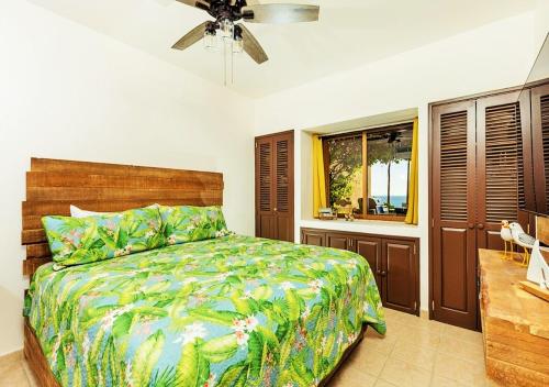 a bedroom with a bed and a ceiling fan at Right on the Beach! 1 Bedroom Ground Floor Ocean Front in Puerto Peñasco