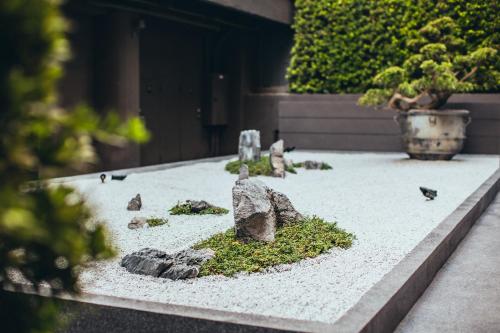 a garden with rocks and birds on the ground at Mega Hotel in Chiayi City