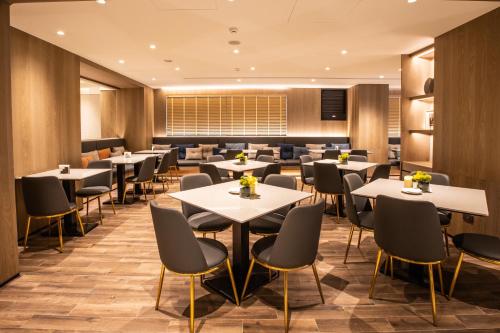 a dining room with tables and chairs at Mega Hotel in Chiayi City