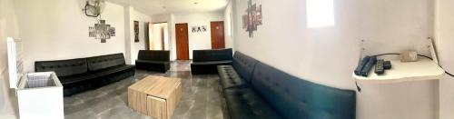 a waiting room with chairs and a phone in a room at Casa La Parcela en Cieneguilla in Cieneguilla