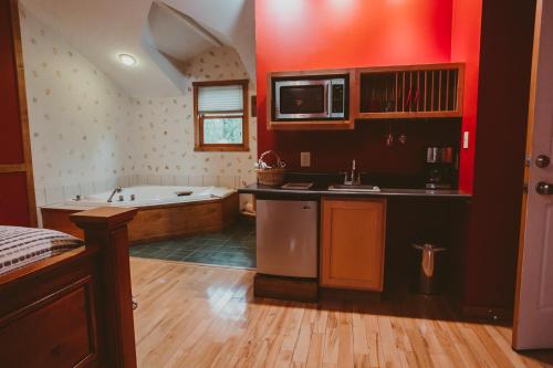 uma cozinha com uma banheira e uma cozinha com um lavatório em Garden Grove Inn Bed and Breakfast em Union Pier