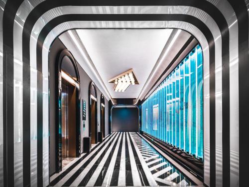 a corridor of a subway train with blue windows at Radisson RED Hotel Zhuhai Gongbei Port in Zhuhai