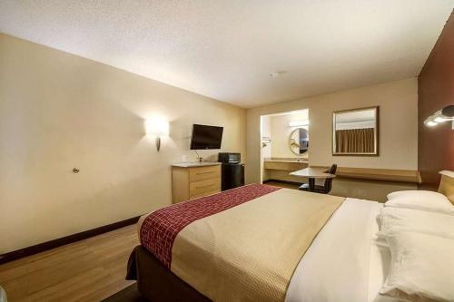a hotel room with a bed and a television at Travelodge by Wyndham San Antonio Lackland AFB North in San Antonio