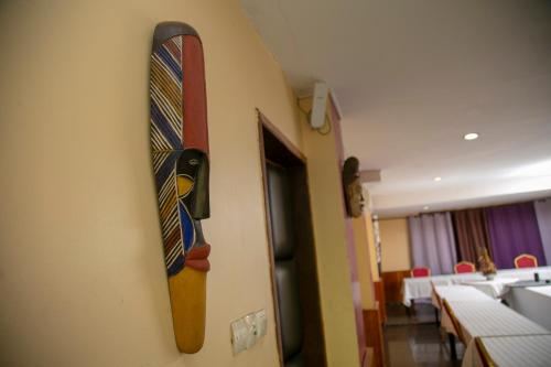 a tie hanging on a wall in a room at Yaahot in Yaoundé