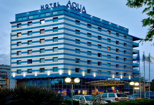 a building with a sign on top of it at Aqua Hotel in Burgas City