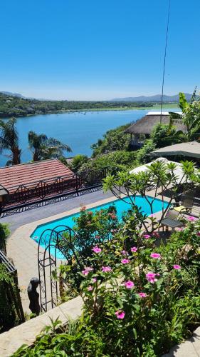 a swimming pool with a view of a body of water at Cozy Kosmos in Hartbeespoort