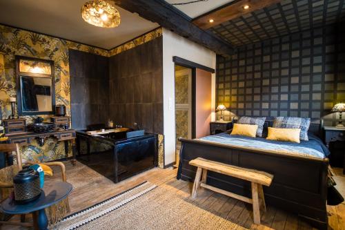 a bedroom with a bed and a sink and a desk at Cosy Central House with luxury jacuzzi bath in Hesdin