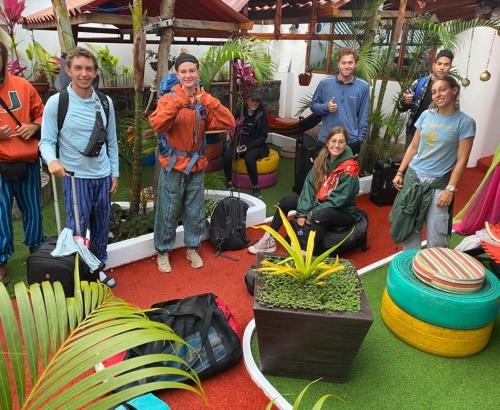 a group of people standing in a room with plants at Hostal Gosén in Puerto Baquerizo Moreno