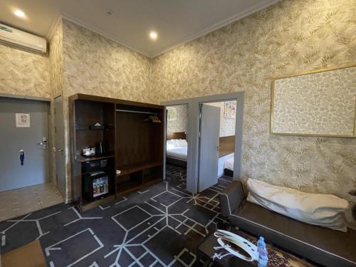 a living room with a couch and a bed at City Centre Hotel in Tashkent
