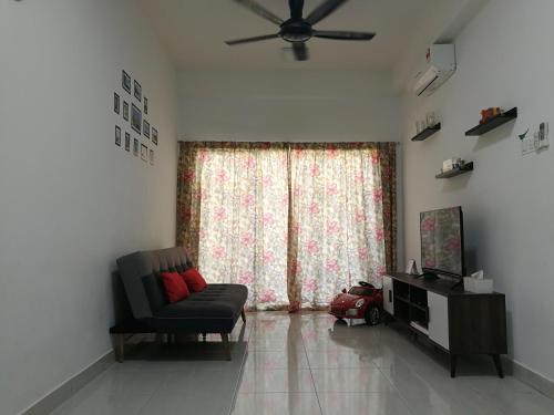 a living room with a couch and a window at BSP21 in Jenjarum