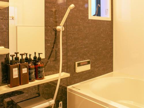 a bathroom with a bath tub and a shower at Samurai House in Nagoya