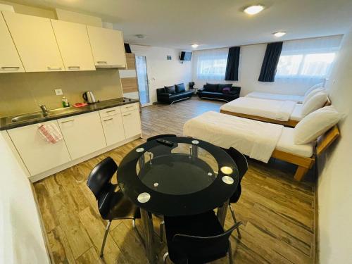 a room with a bed and a table and a kitchen at Swiss Chalet Holidays Ringgenberg in Ringgenberg