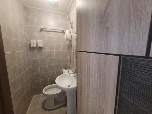a bathroom with a toilet and a sink at Olive Hostel MyeongDong in Seoul