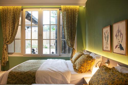 a bedroom with a bed and a window at Villa Rone By The Villas 100 in Bogor