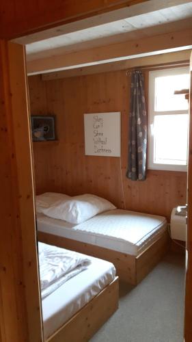 two bunk beds in a room with a window at Zirbenhütte in Hohentauern