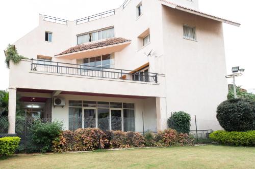 a large white building with a balcony at Treebo Trend Fort Club in Hyderabad