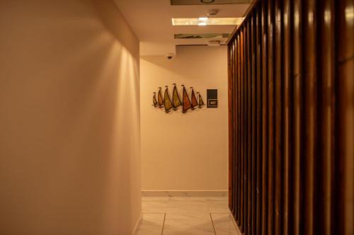 a hallway with a group of oars on the wall at Dhimyaath Stay in Male City